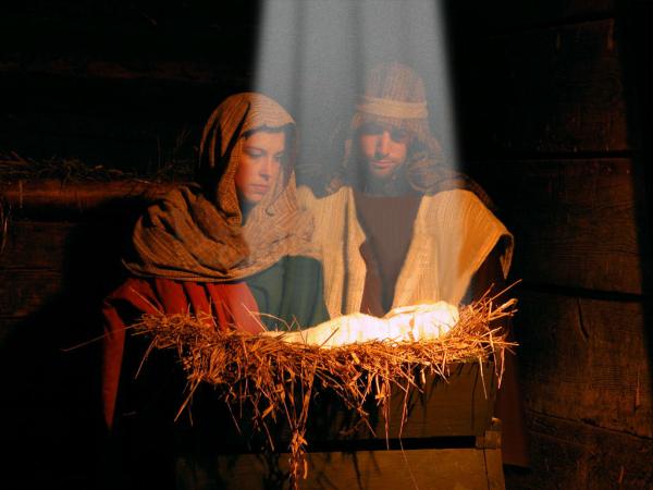 Holy light shines upon Mary, Joseph, and baby Jesus